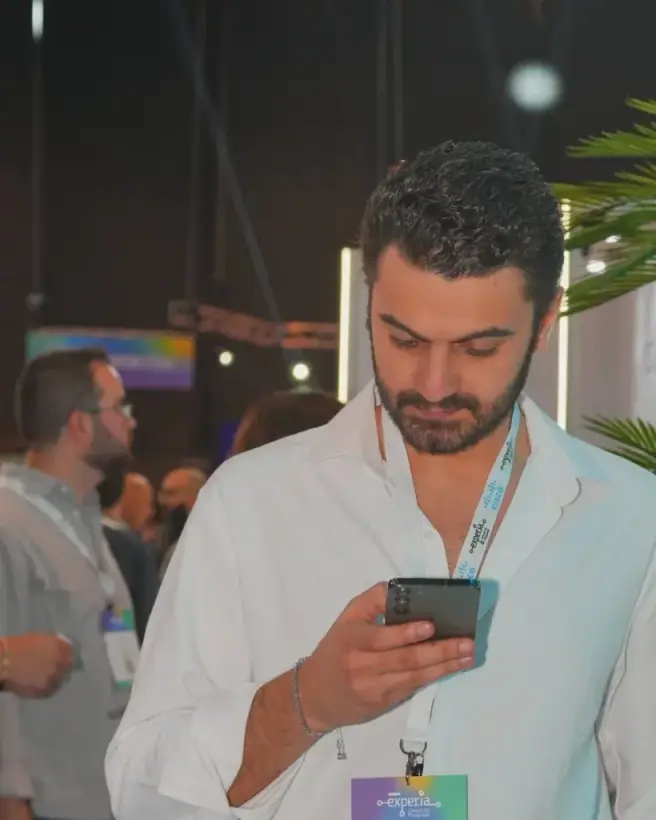 Karim Hasan checking the gold market on his phone